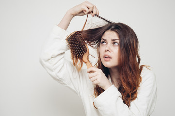 woman combs red hair, scalp care, massage