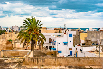 A street in Medina in Sousse, Tunisia. Magical space of medieval town with colorful walls and green...