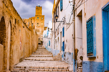A street in Medina in Sousse, Tunisia. Magical space of medieval town with colorful walls and stone pavement. - 133443574