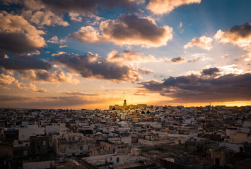 View of the Medina and the castle kasbah in Sousse, Tunisia. Cityscape of Sousse at dramatic sunset with red skies and clouds.