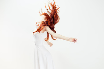 girl in white dress jumping on white background