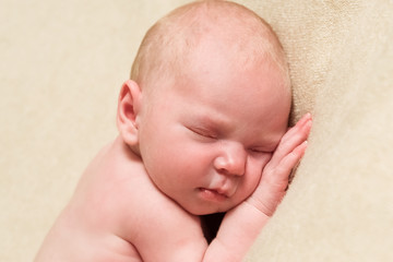 Newborn baby sleeping on a blanket. Close-up