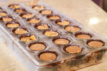 Filling out candy mold form with the chocolate
