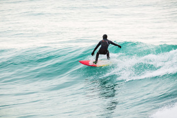 Surfer on wave in ocean. Winter