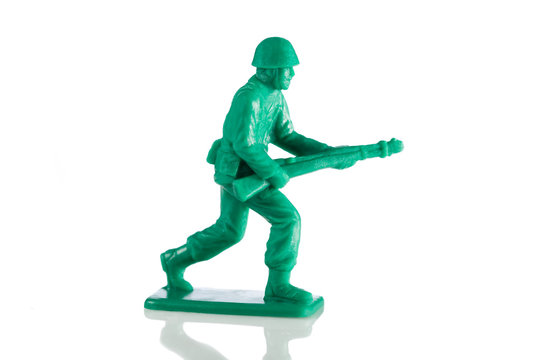 Miniature plastic toy soldier on white background