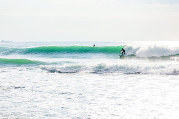 Obraz premium Clear wave and surfer in ocean. Sunny day