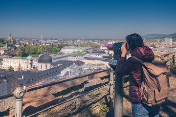 Fototapeta na wymiar Austria. Salzburg. The girl tourist on the observation deck with views of the city and park Mirabellgarten