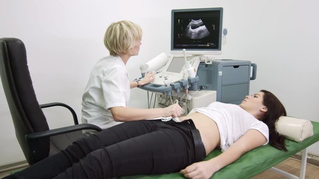 Ultrasound examination, doctor explain diagnosis for patient