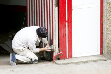 painter man working for repairing and painting the garaje door