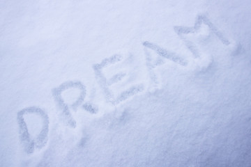 Inscription dream on white snow