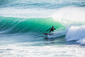 Fototapeta na wymiar Surfing on turquoise wave in ocean