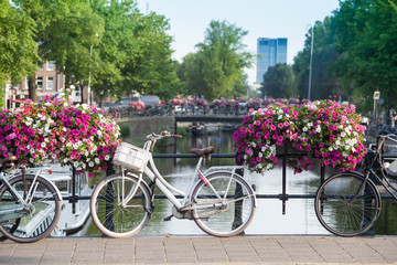 Fototapeta na wymiar Bicycles on bridge over Amsterdam canal background