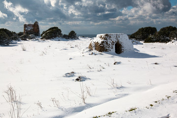 Uluzzo tower after a exceptional snowfall, Salento, Italy