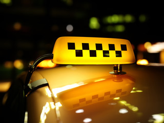 Yellow taxi sign checker at night