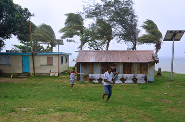 Fijian people run to get shelter during a Tropical Cyclon
