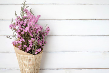 Wild flower bouquet on vintage white wood background