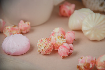 beze, popcorn on wooden background