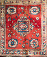 Old red turkish carpet with traditional motif.