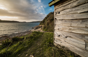 close up of boathouse on bank of helford river cornwall
