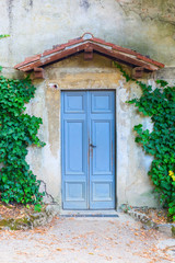 Fototapeta na wymiar old door with small roof in Tuscany, Italy