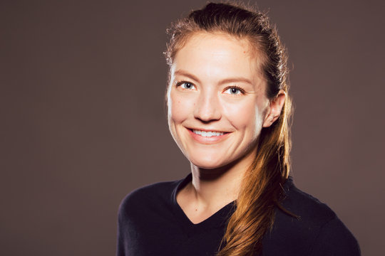 Young caucasian woman looks at viewer with a smile