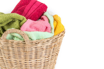 close up color mix  towel in wicker baskets on white background