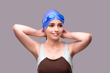 Woman swimmer against grey background