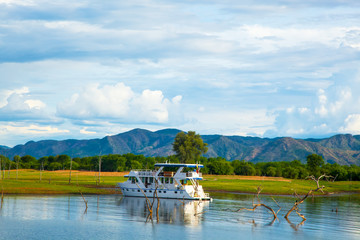 Lake Kariba Dam Reflections On the Water.  House Boat and Clouds. - obrazy, fototapety, plakaty