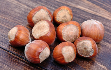 Group of hazelnuts on wooden background
