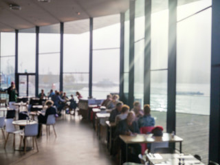 Blurred cafe, and restaurant with sea view and sun light