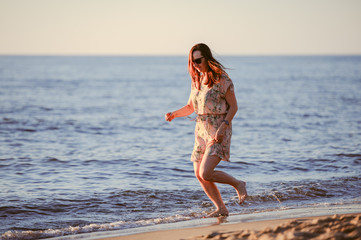 People walking on the beach in the ocean.