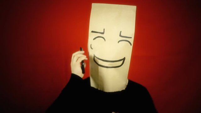 A shy bashful breadbag face, in a conversation on a smartphone. Close-up shot.
