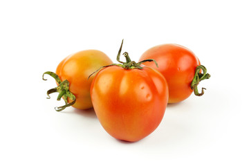 fresh tomatoes with green leaves isolated on white background