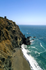 California coastline with sand beach and large towering cliffs