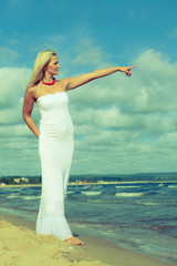 Fototapeta na wymiar Beauty blonde woman pointing to sky.