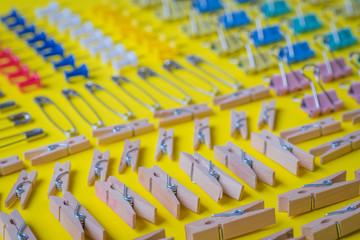 Pins and paper clips collection, yellow background