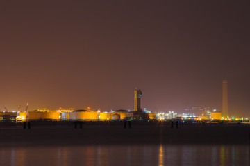 Fototapeta na wymiar electrical power plant near sea coat at night, Rayong, Thailand
