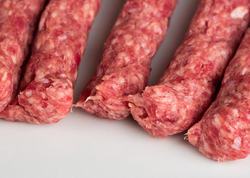 Raw kebabs on white background, quality minced meat special