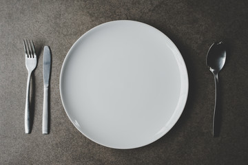 Spoon and Fork Tied on a White Napkin on Wooden Table