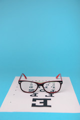 glasses lying on snellen test chart