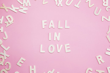 Sorting letters Fall in love on pink.