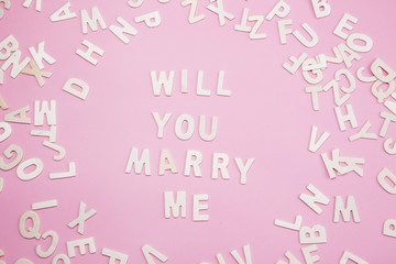 Sorting letters Will you marry me on pink.
