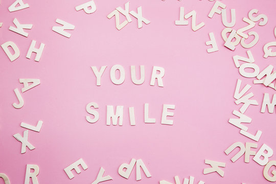 Sorting letters Your smile on pink.