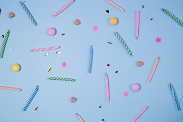 Candles for birthday party on blue background.