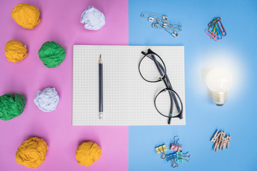 Flat lay, top view office table desk. feminine desk workspace with succulent, glasses, diary on pink and blue background, new idea