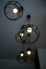 Fototapeta na wymiar Vintage hanging light bulb over grey room