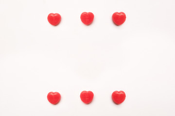 Red Valentine's day heart shape candy pattern on empty white paper background. Love Concept. colorful hipster style. Knolling top view.