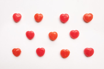 Red Valentine's day heart shape candy pattern on empty white paper background. Love Concept. colorful hipster style. Knolling top view.