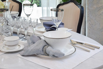 elegant table set on marble dining table in vintage style dining room interior