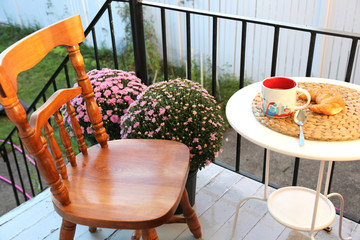 Drinking coffee with croissant in the cafe